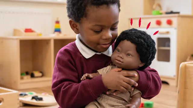 Student playing with diverse doll